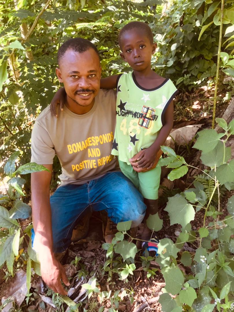 A community member with a young student in Haiti, Haiti Scholarships partner.
