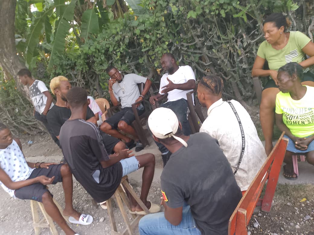 A circle of community members in conversation, Haiti.