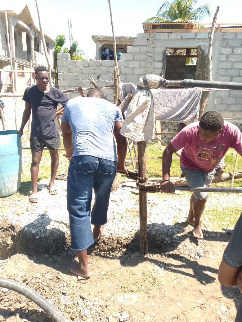 A construction site in Haiti where the crew is drilling and building.